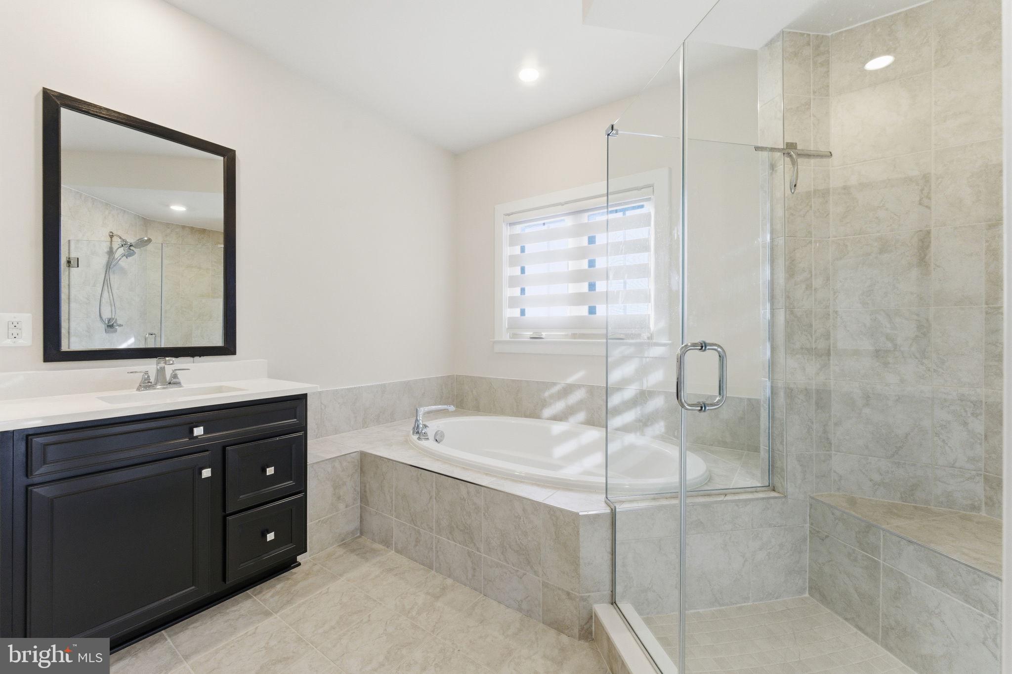 3754 Mayors Way Fairfax, VA 22030 - Photo 35 of 57 a bathroom with a tub a sink and mirror