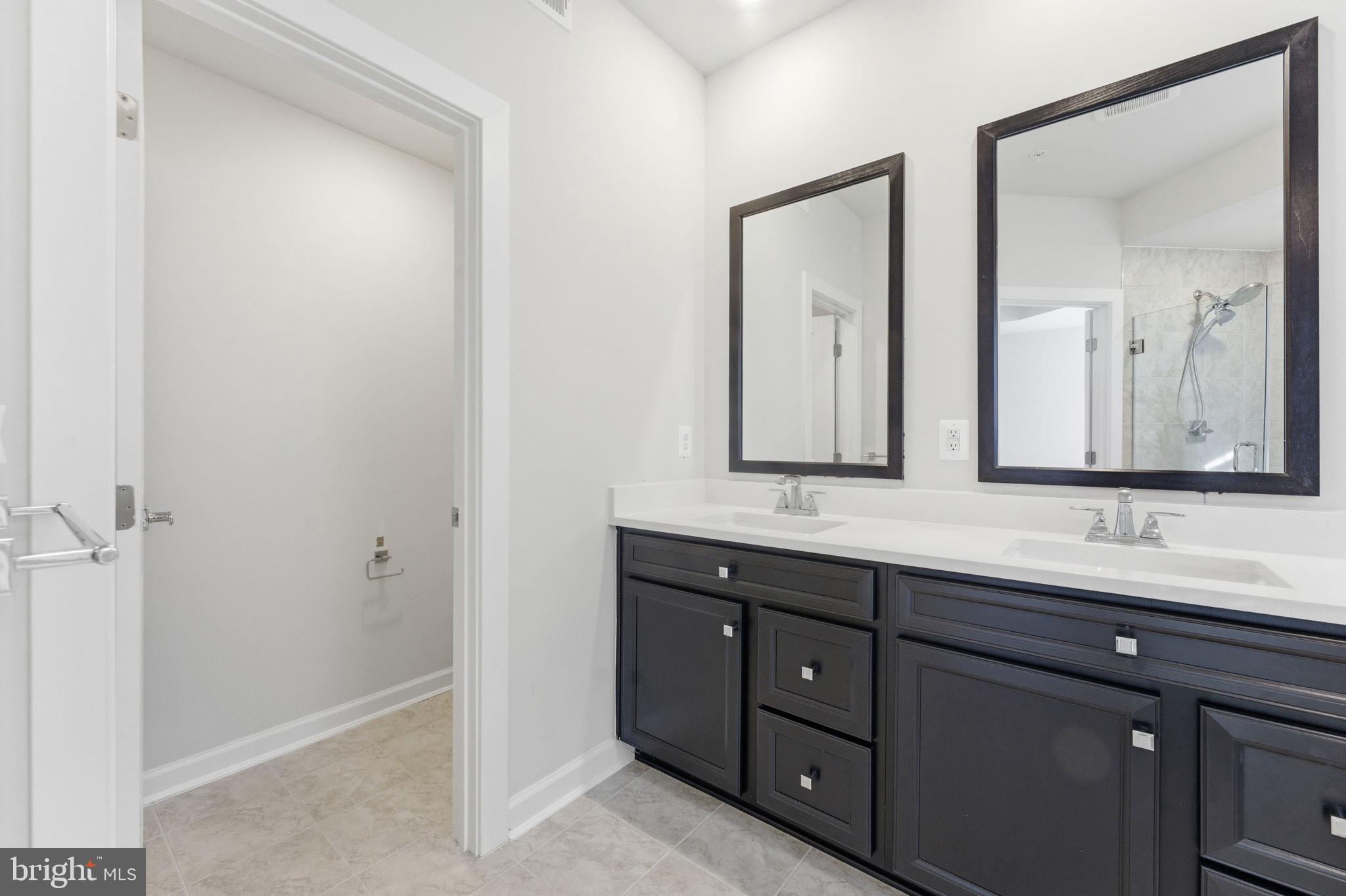 3754 Mayors Way Fairfax, VA 22030 - Photo 36 of 57 a bathroom with a double vanity sink and mirror
