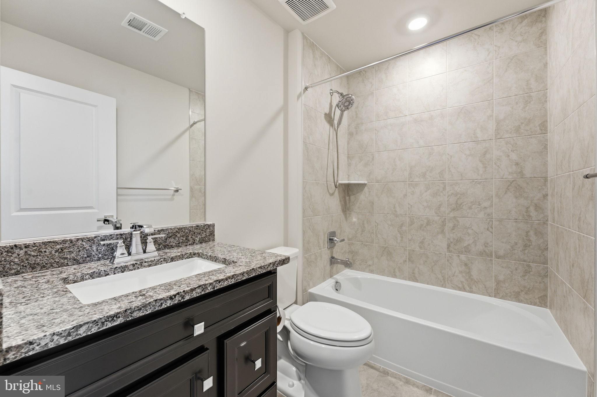 3754 Mayors Way Fairfax, VA 22030 - Photo 40 of 57 a bathroom with a granite countertop sink toilet and shower