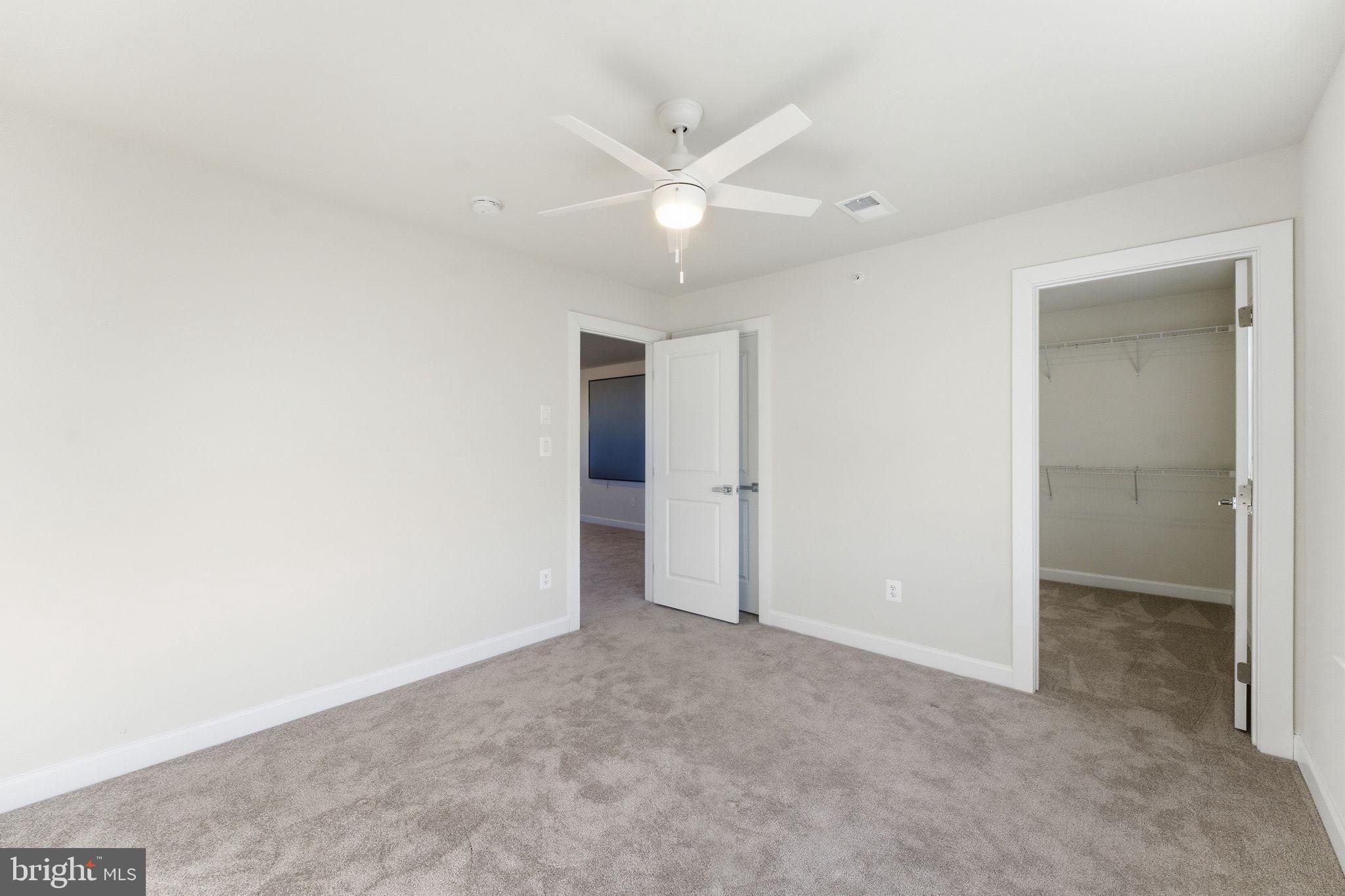 3754 Mayors Way Fairfax, VA 22030 - Photo 50 of 57 an empty room with closet and ceiling fan