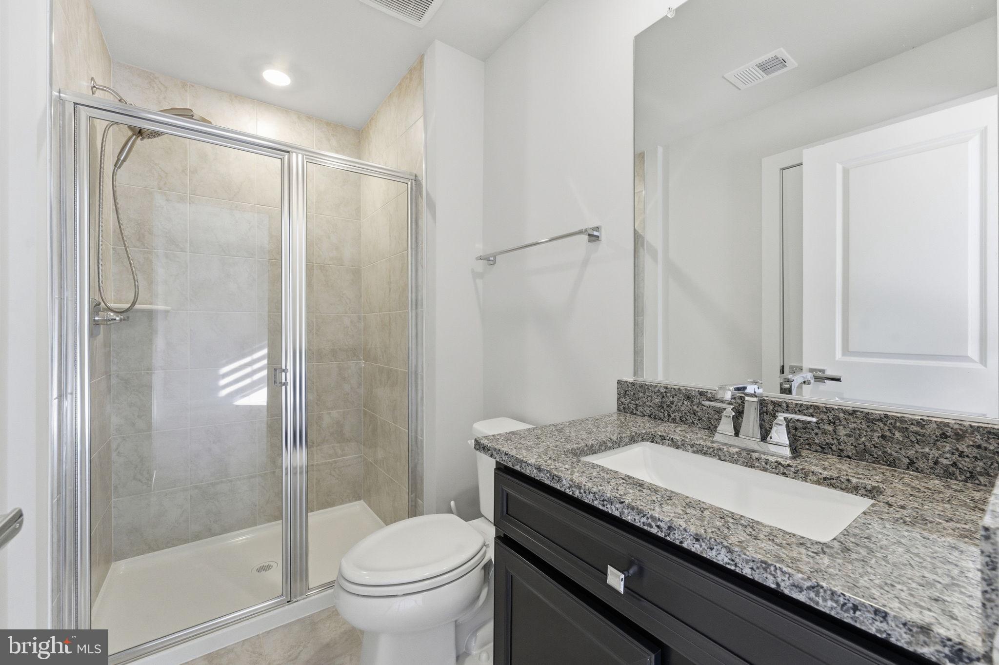 3754 Mayors Way Fairfax, VA 22030 - Photo 52 of 57 a bathroom with a granite countertop sink a toilet and shower