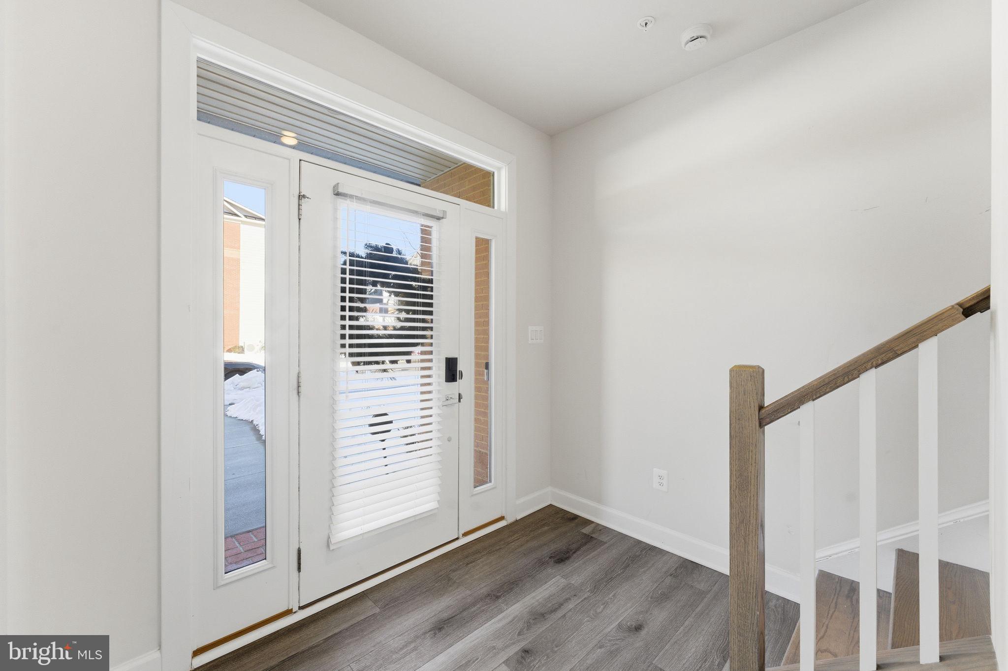 3754 Mayors Way Fairfax, VA 22030 - Photo 6 of 57 a view of a hallway with wooden floor and staircase
