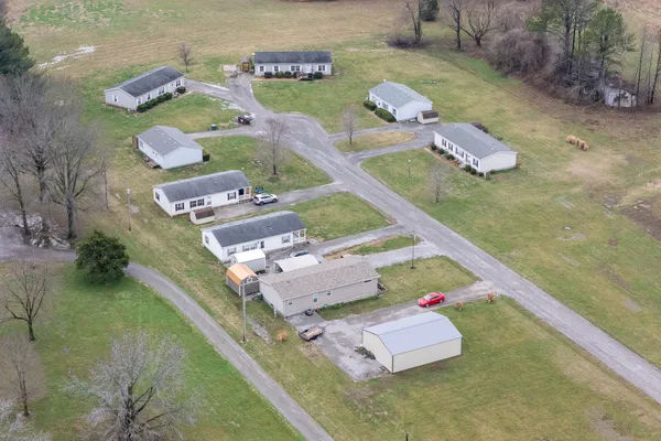 an aerial view of a house with a yard