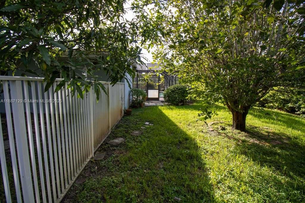 9041 Southwest 88th Street, Unit 9041 Miami, FL 33173 - Photo 14 of 34 a view of a yard with wooden fence