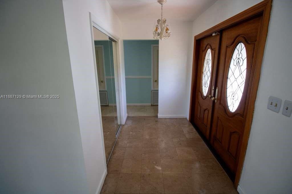 9041 Southwest 88th Street, Unit 9041 Miami, FL 33173 - Photo 18 of 34 an entryway with a mirror