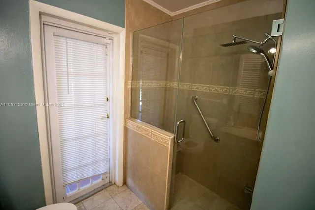a bathroom with a glass shower door