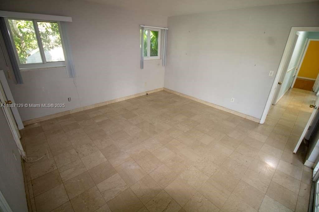 9041 Southwest 88th Street, Unit 9041 Miami, FL 33173 - Photo 28 of 34 an empty room with windows