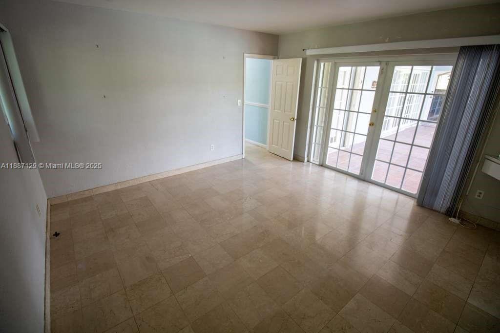 9041 Southwest 88th Street, Unit 9041 Miami, FL 33173 - Photo 29 of 34 a view of an empty room with a window
