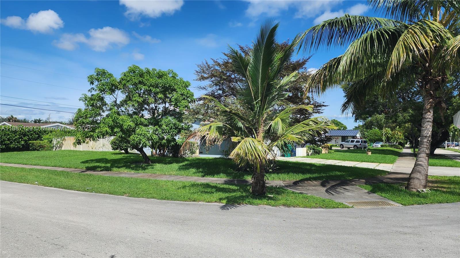 9041 Southwest 88th Street, Unit 9041 Miami, FL 33173 - Photo 5 of 34 a front view of a house with a yard and potted plants
