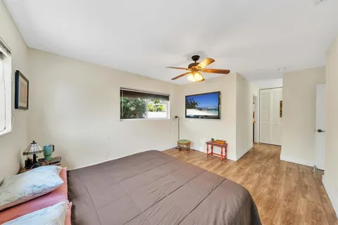 a bathroom with a granite countertop sink mirror and a shower
