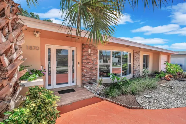 a view of a hallway with wooden floor and closet