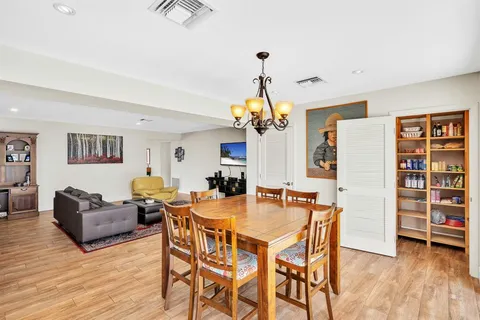 a view of backyard with swimming pool and seating space