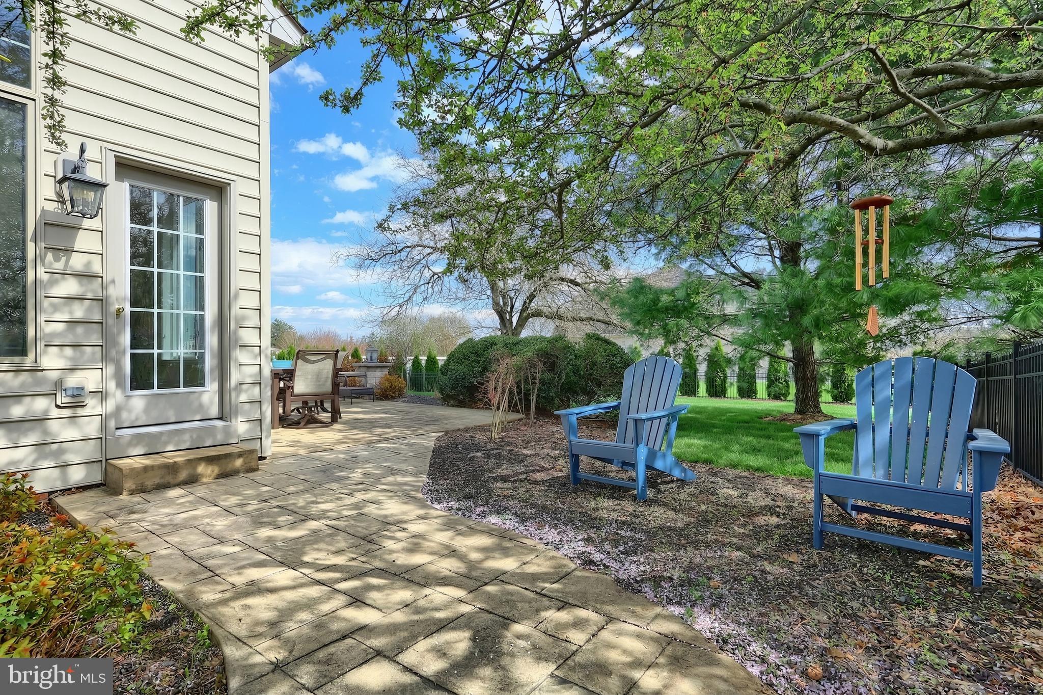 2119 Bernays Drive York, PA 17404 - Photo 12 of 72 a view of a backyard with table and chairs and a barbeque with potted plants and large trees