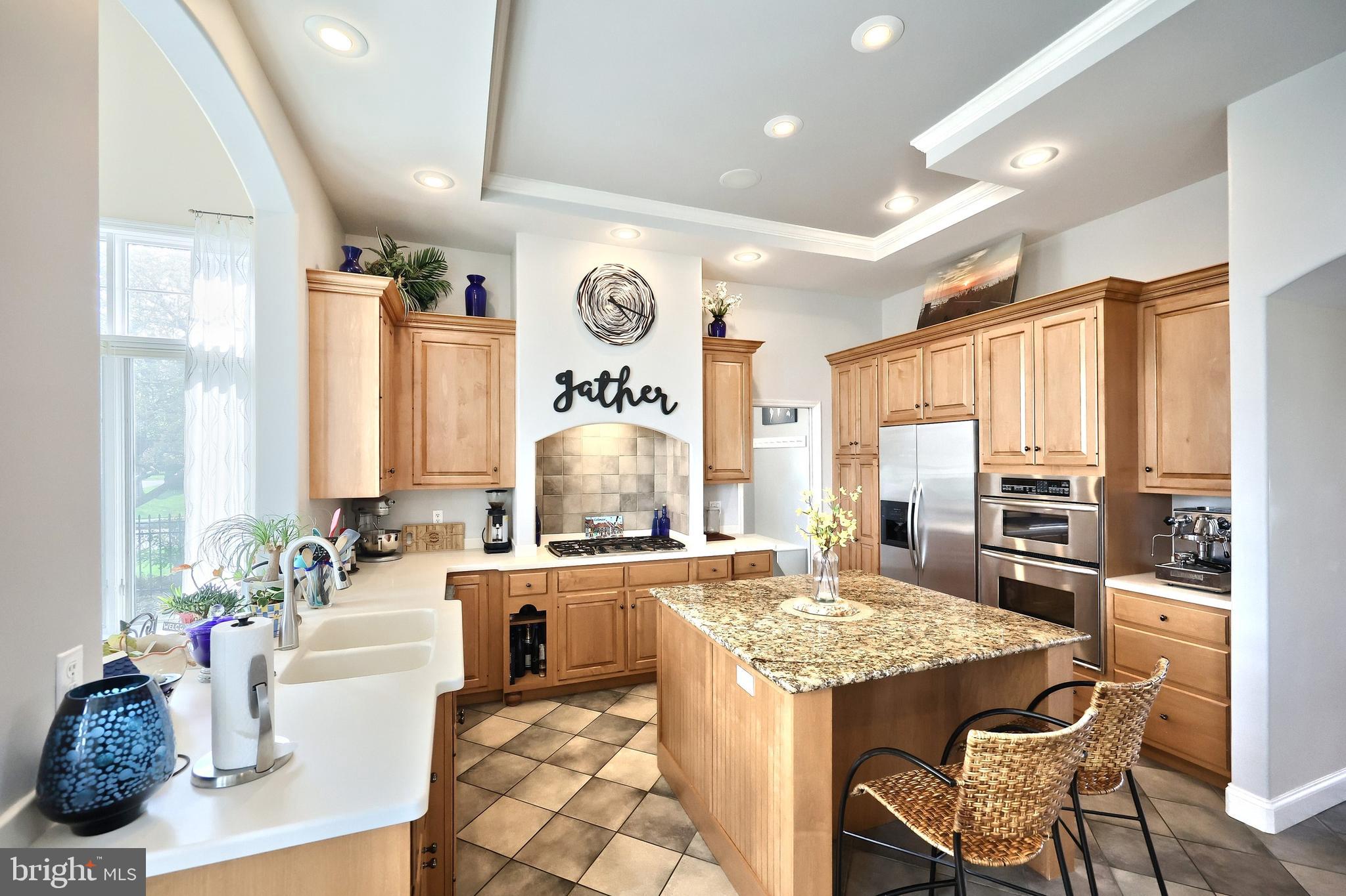 2119 Bernays Drive York, PA 17404 - Photo 33 of 72 a view of a kitchen with kitchen island granite countertop a large window cabinets a sink and stainless steel appliances