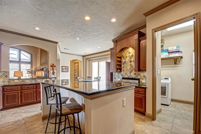 a very nice looking kitchen with a large window and stainless steel appliances