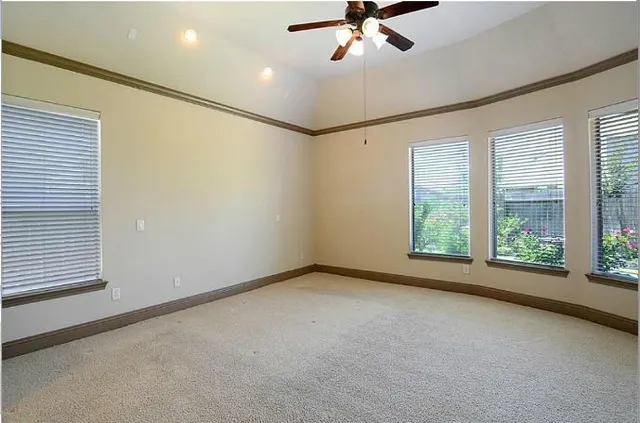 a view of a livingroom with a ceiling fan and window