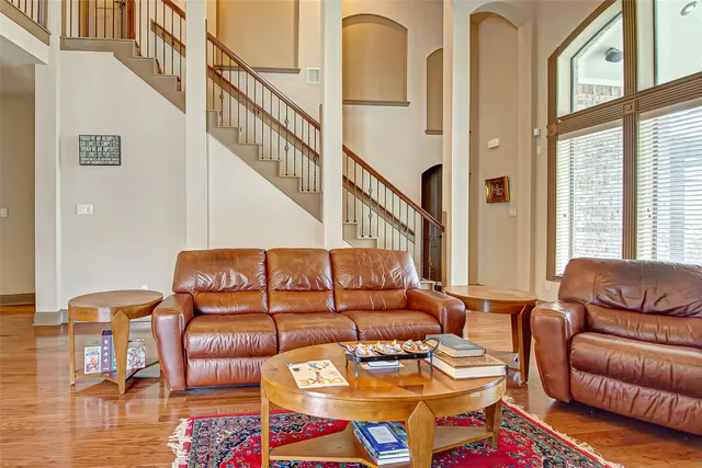 a living room with furniture a rug and a window