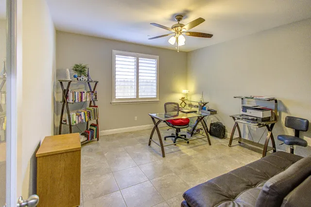 a view of a dining room with furniture and a potted plant
