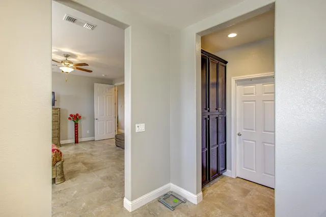 a workspace with furniture and a ceiling fan
