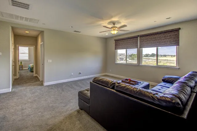 a view of a house with a barbeque and trees