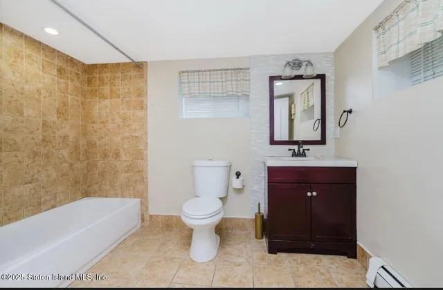 a bathroom with a sink a toilet and bathtub