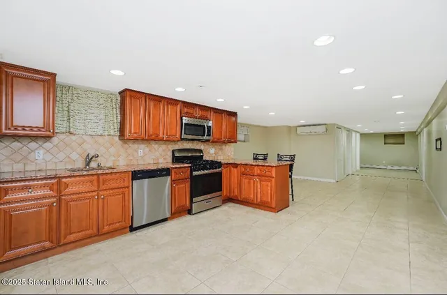 a large kitchen with stainless steel appliances lots of counter top space