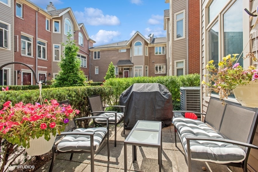 1231 West Fletcher Street, Unit A Chicago, IL 60657 - Photo 15 of 20 a view of yard with seating area and flowers