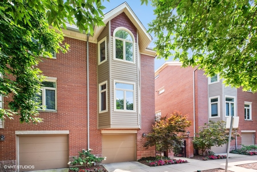 1231 West Fletcher Street, Unit A Chicago, IL 60657 - Photo 2 of 20 a front view of a house with a yard