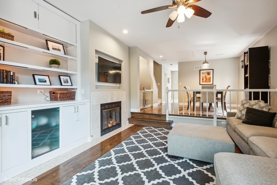 1231 West Fletcher Street, Unit A Chicago, IL 60657 - Photo 3 of 20 a living room with furniture fireplace and flat screen tv
