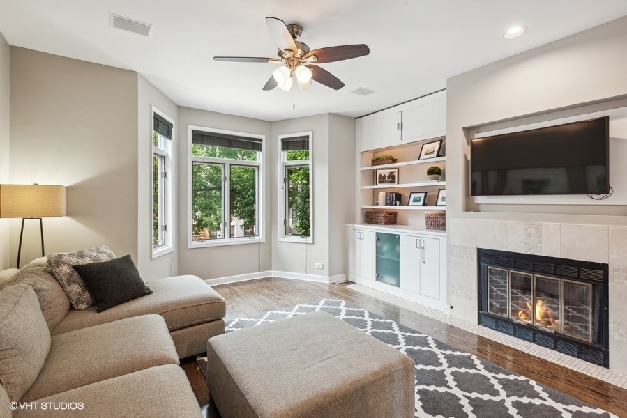 1231 West Fletcher Street, Unit A Chicago, IL 60657 - Photo 4 of 20 a living room with furniture a flat screen tv and a fireplace