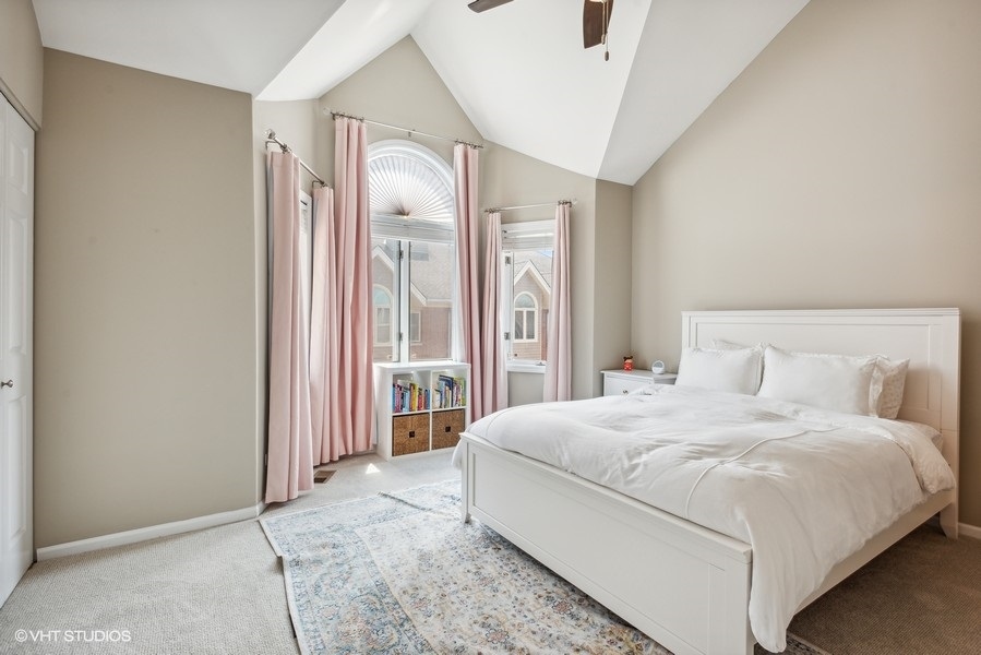 1231 West Fletcher Street, Unit A Chicago, IL 60657 - Photo 10 of 20 a bedroom with a large bed and a chandelier