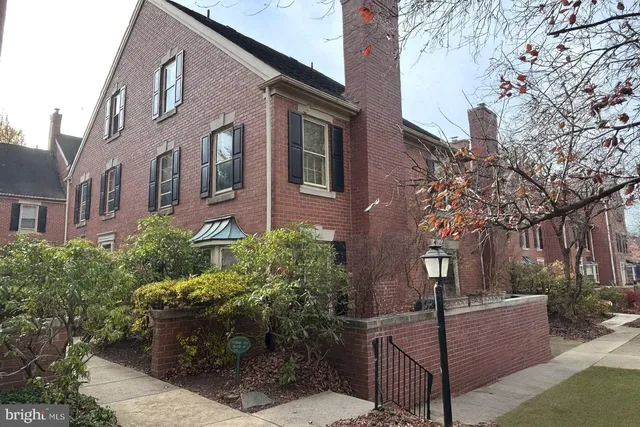 a view of a brick house with many windows