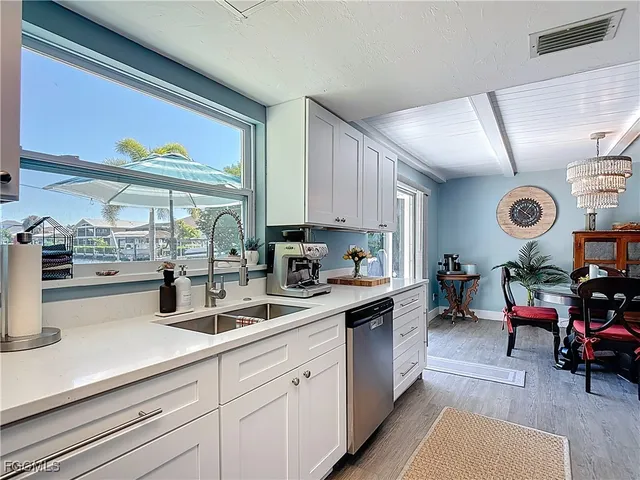 a kitchen with sink cabinets and window