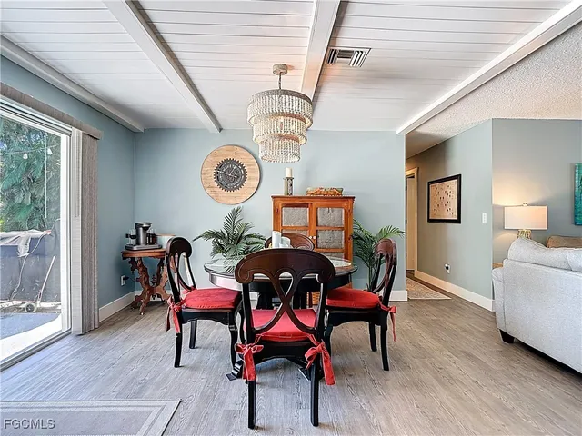 a view of a dining room with furniture and chandelier