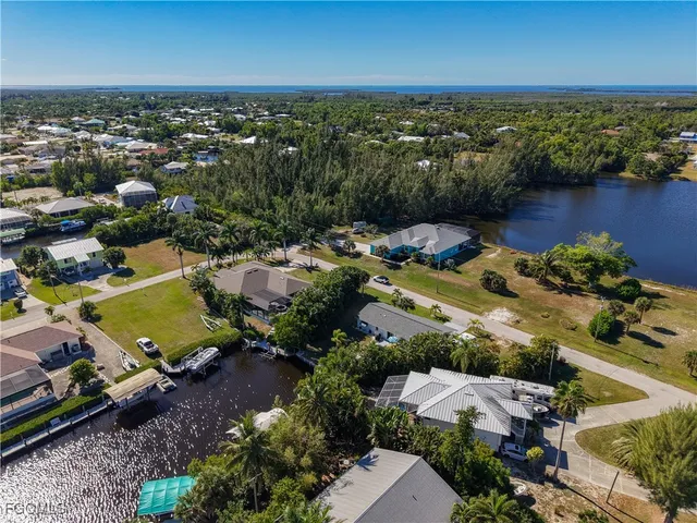 an aerial view of a houses with a lake view