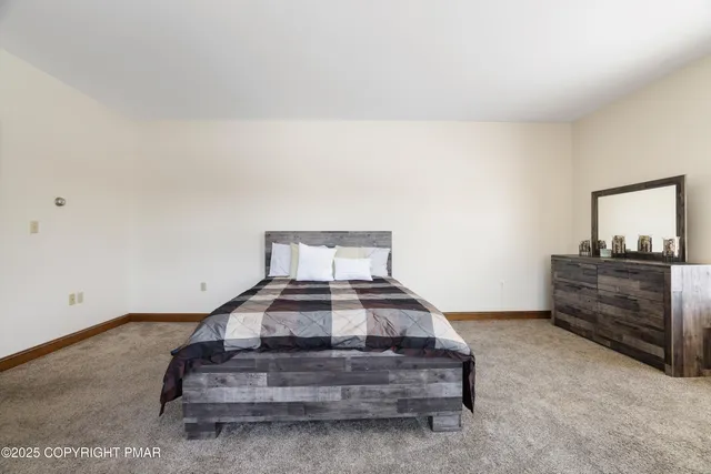 a bathroom with a granite countertop sink a toilet and a mirror