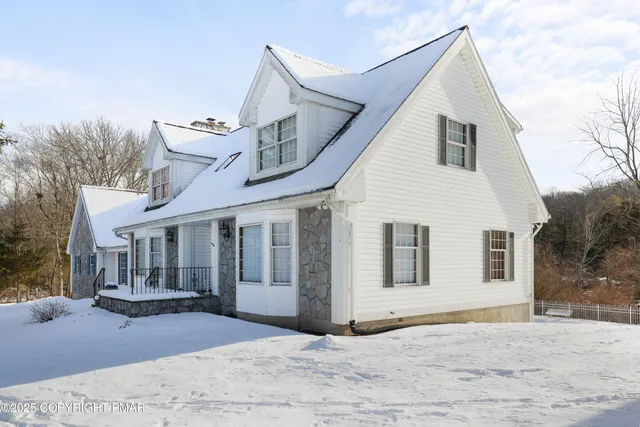 a dining hall with stainless steel appliances granite countertop a stove a refrigerator a dining table and chairs with wooden floor