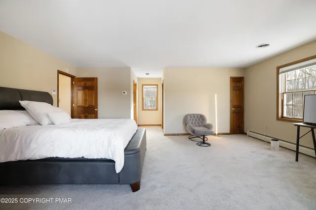a bathroom with a shower curtain and a window