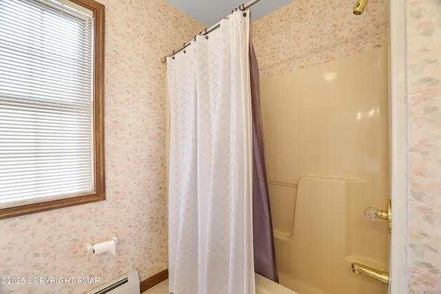 a view of a white house with a yard and pathway