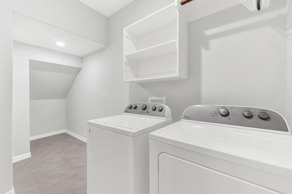 7640 Rhyner Way Fort Worth, TX 76137 - Photo 9 of 40 Dedicated laundry room featuring side-by-side washer and dryer units with intuitive control panels, white cabinetry with open shelving for storage, wood-finish flooring, recessed lighting, and direct access to additional storage space