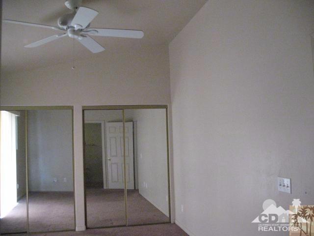 10762 San Pablo Road Desert Hot Springs, CA 92240 - Photo 6 of 9 an empty room with a mirror and fan