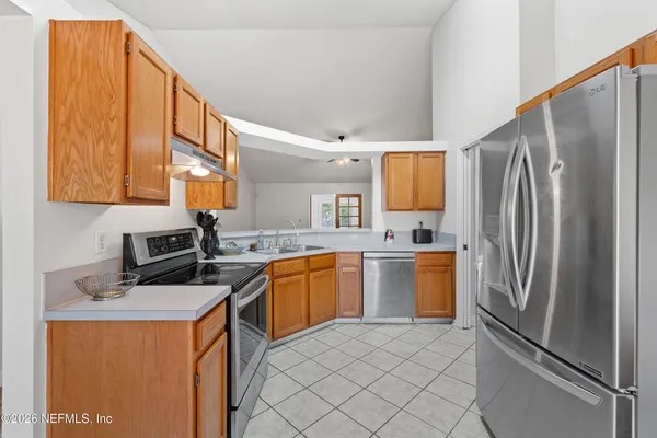 a kitchen with a refrigerator sink and stove
