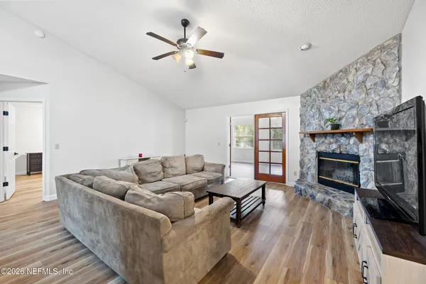 a living room with furniture and a fireplace