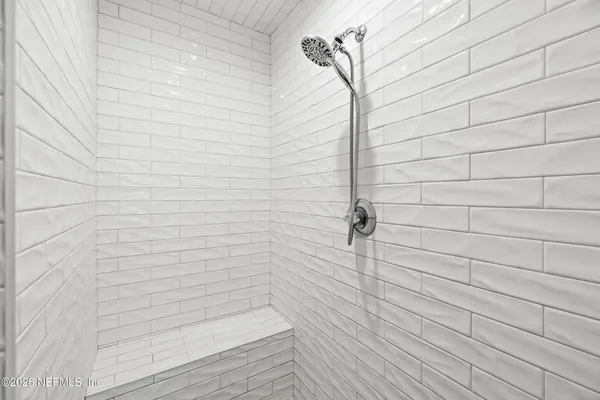 a white bath tub sitting next to a white sink