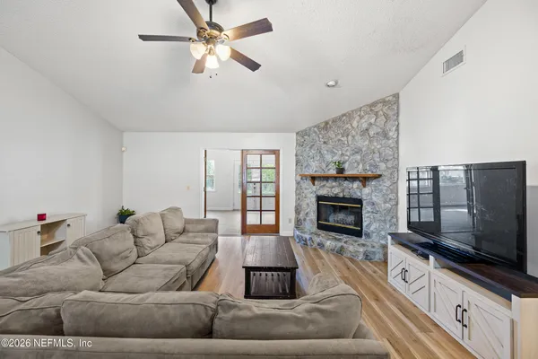 a living room with furniture flat screen tv and a fireplace