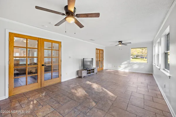 a view of kitchen with granite countertop cabinets and window