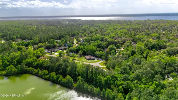 an aerial view of a house with a yard and swimming pool