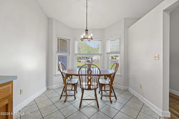 a dining room with furniture and window