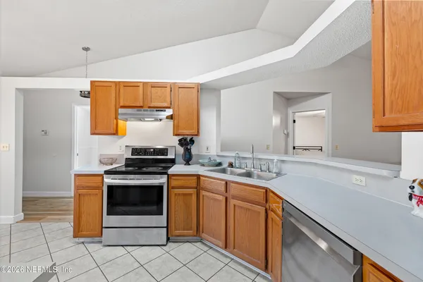 a kitchen with sink cabinets and a window