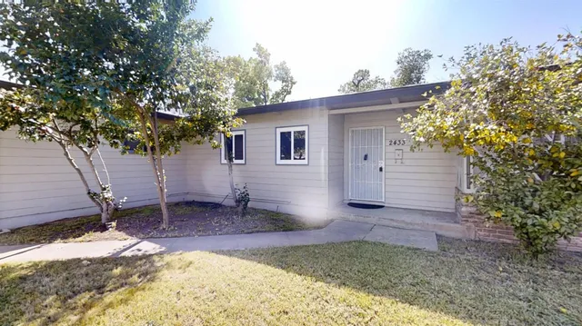 a backyard of a house with table and chairs